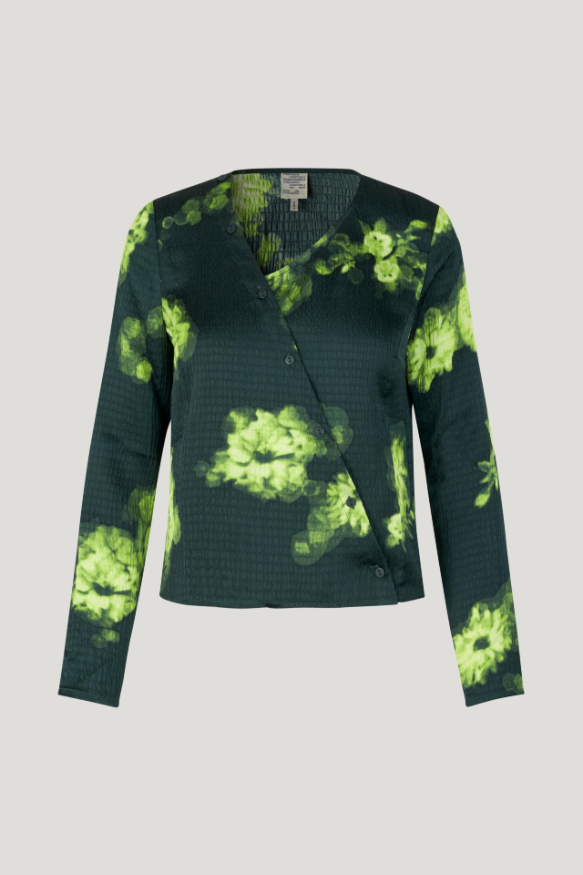 Maia Blouse Green Margot Flower This soft top features an asymmetrical neckline and button closures with extra buttons running up the neck - front image