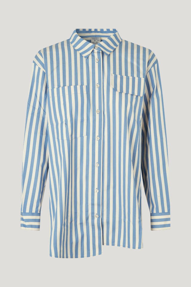 Molli Shirt Wide Blue Stripe This collared, button-up shirt features an asymmetrical hem, buttoned cuffs, and a patch pocket at the chest - front image
