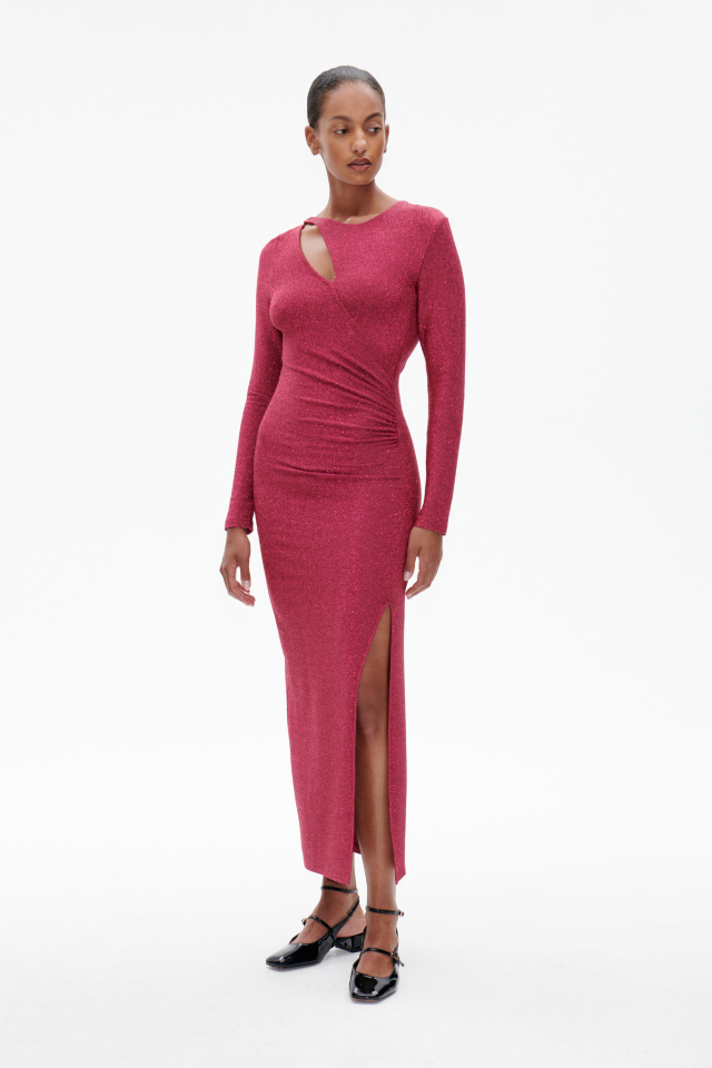 Jilliane Dress Shimmer Pink This stretchy, metallic maxi dress features a high slit at the front side, ruching at the waist for a flattering drape, and an asymmetrical keyhole opening at the side of the collarbone - model image