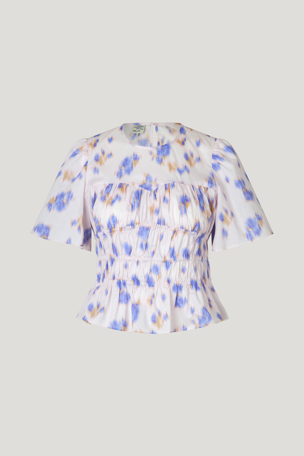 Marissa Top Purple Fleur Fanee This short sleeved top features elasticated panels throughout the body and a flare at the hem for a flattering silhouette - front image