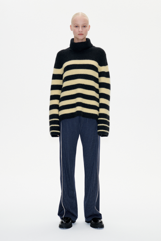 Chikita Sweater Black Yellow Breton This soft, knit turtleneck jumper features slits at the sides and a dipped hem - model image