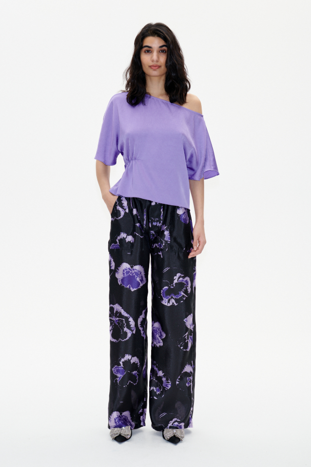 Margeaux Blouse Dahlia Purple This fluid top features an asymmetrical neckline, flutter sleeves, and ruching to one side for a flattering drape - model image