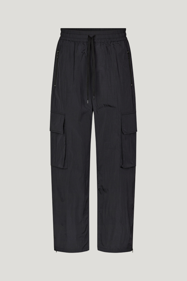 Nemu Trousers Black These high-rise, nylon trousers feature an elasticated waistband with a drawstring, zip pockets at the sides, cargo pockets on the legs, and zips at the ankles - front image
