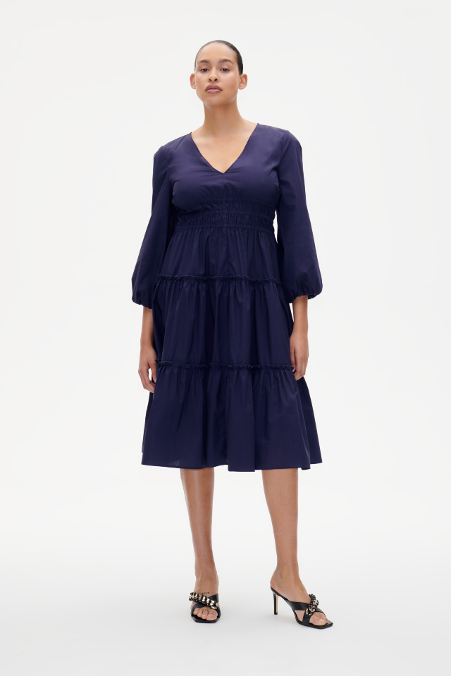 Amela Dress Inkling Blue This midi-length dress features a V-neckand elasticated smocking at the waist for a comfortable fit - model image