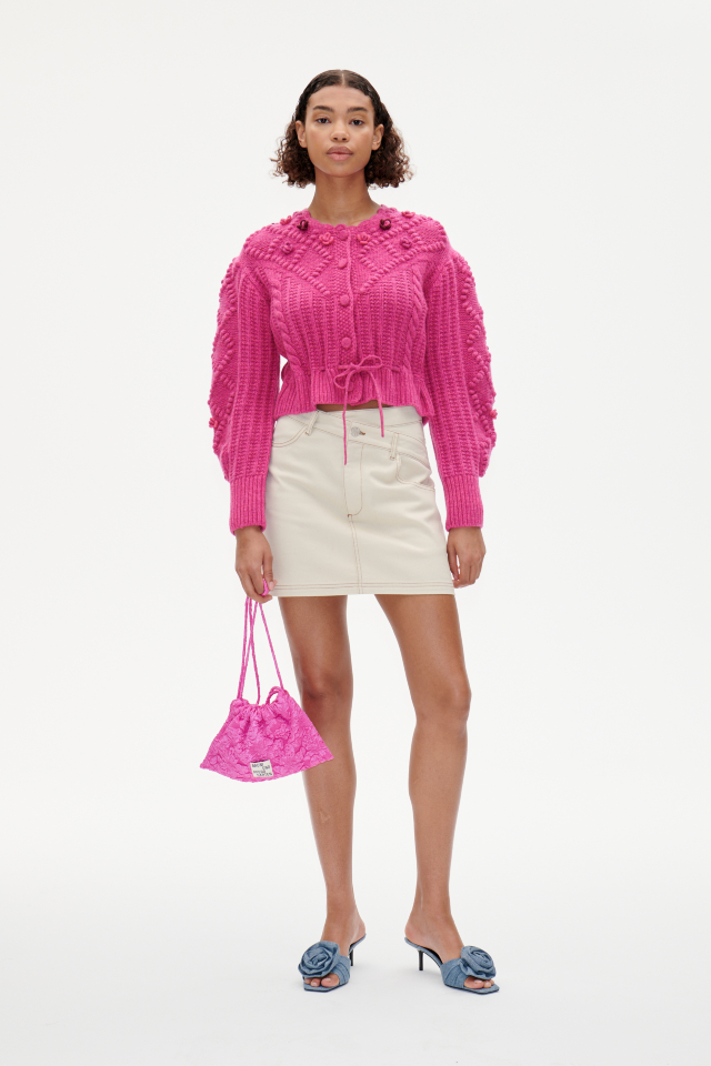 Cava Cardigan Rose Violet This thick knit, cropped cardigan features large button closures, a tie belt at the hem, and a scalloped neckline - model image
