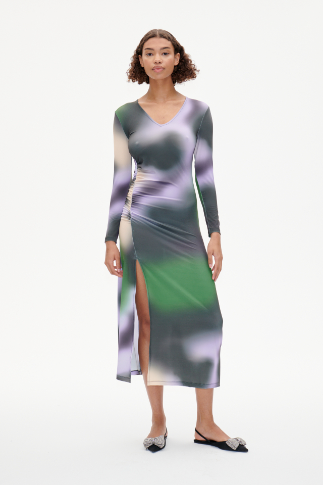 Jua Dress Green Fade This stretchy, soft midi-length dress features a V-neck, slit at the front side, and ruching at the side waist for a flattering drape - model image