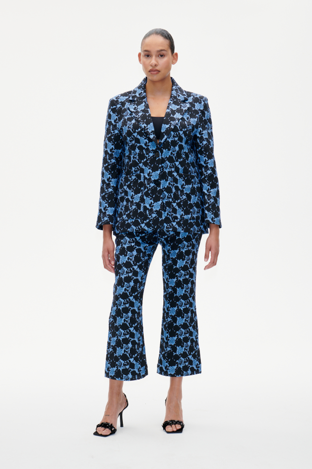 Nenne Trousers Blue Flower Jacquard These mid-rise trousers feature a zip closure at the side and slight stretch to the material - model image
